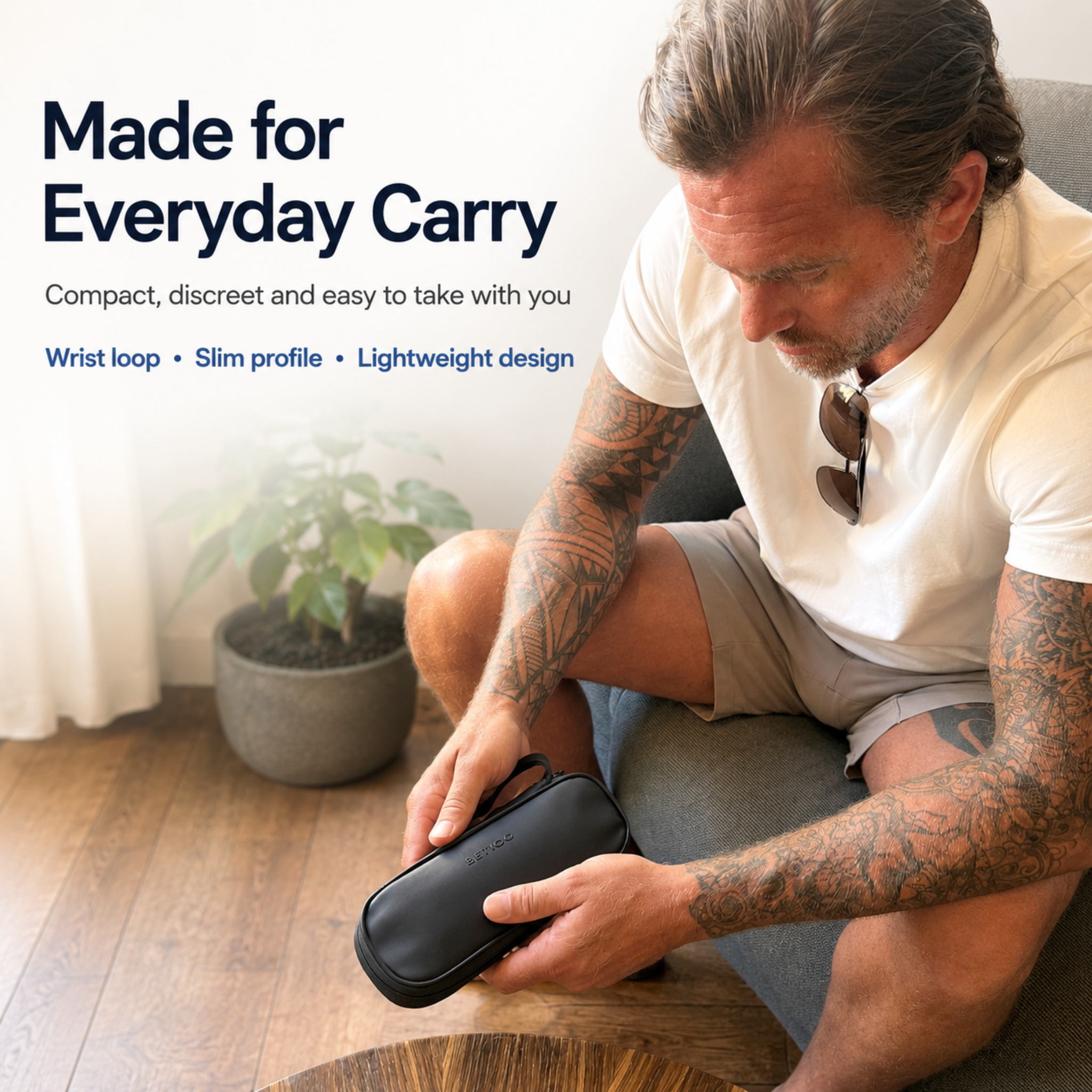 Lifestyle image of the black Betico Cooler Travel Case being held by hand, showing its compact slim profile and wrist loop for everyday carry