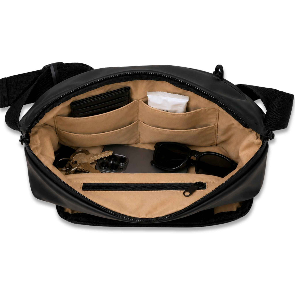 An open black crossbody bag showing its tan interior organiser pockets and compartments, with sample items like sunglasses, keys, and a wallet placed inside, on a white background.