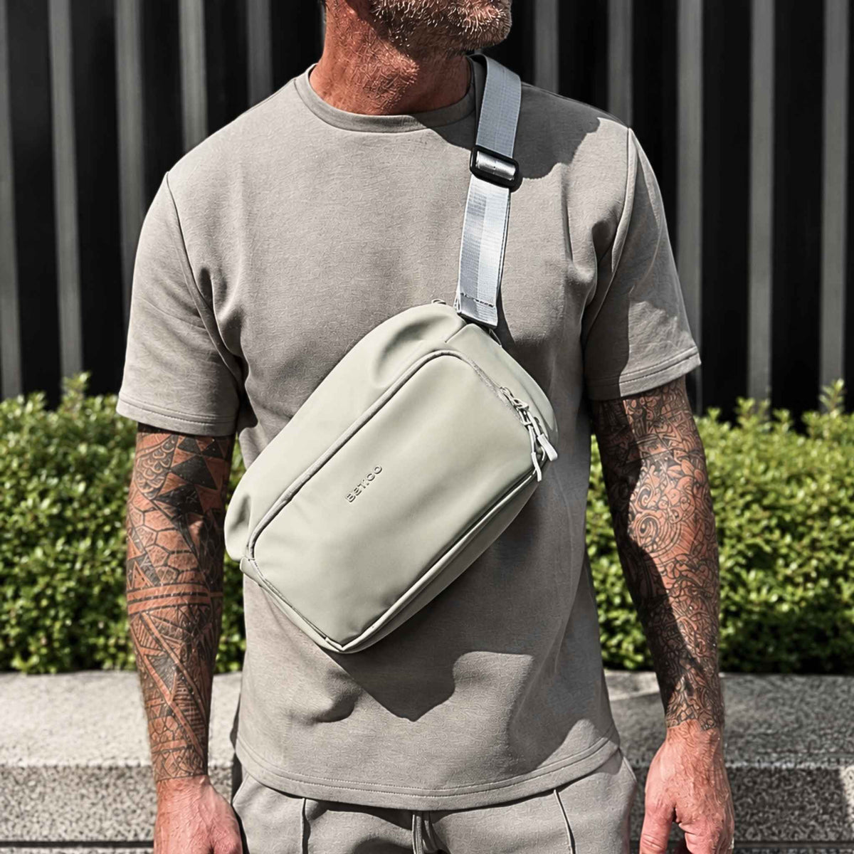Man wearing the green Betico Essential Diabetes Bag crossbody outdoors, showing its adjustable strap and everyday fit.
