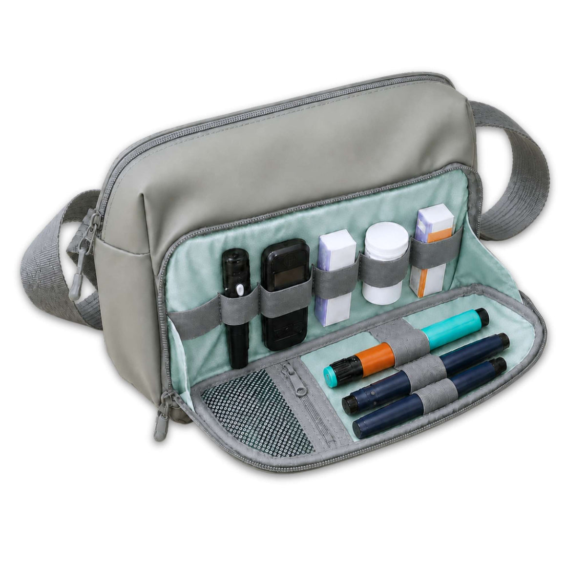Green Betico Essential Diabetes Bag with the front organiser open, showing elasticated loops, a mesh pocket and a secure zip pocket holding diabetes supplies.