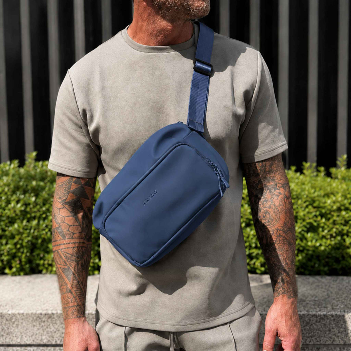 Man wearing the blue Betico Essential Diabetes Bag crossbody outdoors, showing its adjustable strap and everyday fit.