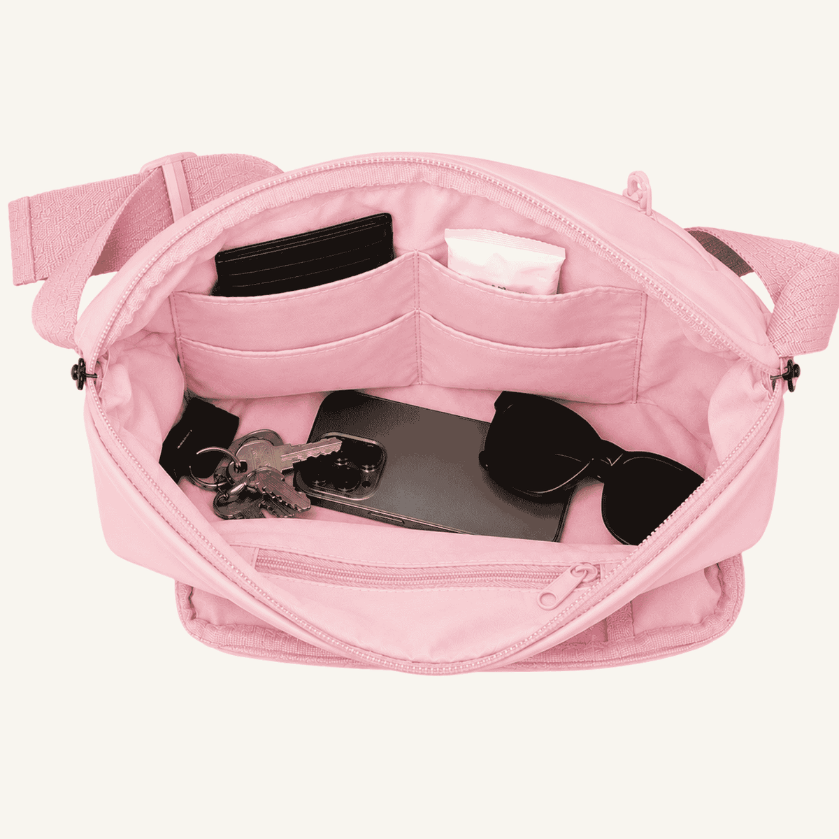 Betico Essential Diabetes Bag in Pink with main compartment open showing internal slip pockets, zip pocket and everyday essentials